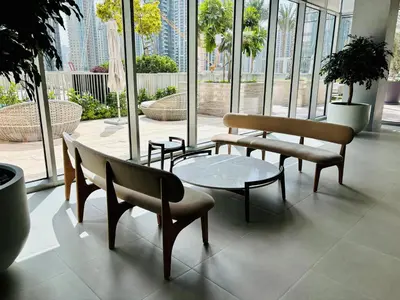 a room with benches and a table and windows at Forte Tower - Downtown Dream, Ocean View, Opposite Dubai Mall in Dubai
