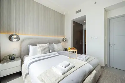 a bedroom with a large bed with towels on it at Forte Tower - Downtown Dream, Ocean View, Opposite Dubai Mall in Dubai