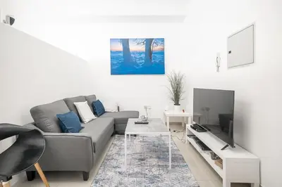 a living room with a couch and a tv at StoneTree - Chic Studio - Near Beach in Dubai
