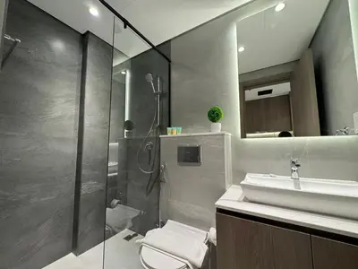 a bathroom with a shower and a toilet and a sink at ASHRI HH, STANDARD STUDIO IN STUDIO CITY in Dubai