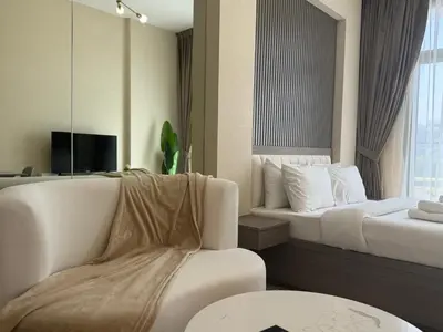 a hotel room with a bed and a couch at ASHRI HH, STANDARD STUDIO IN STUDIO CITY in Dubai