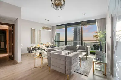 a living room with a couch and a dining table at Luxe 2BR Burj Vista Retreat, Steps from Dubai Mall & Burj Khalifa in Dubai