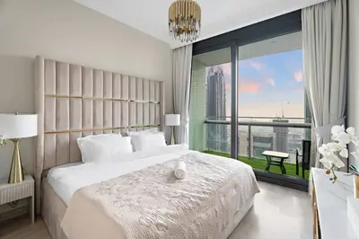 a bedroom with a large bed and a large window at Luxe 2BR Burj Vista Retreat, Steps from Dubai Mall & Burj Khalifa in Dubai
