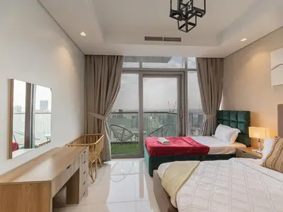 a hotel room with two beds and a window at Spectacular views on high floor with Infinity Pool in Dubai