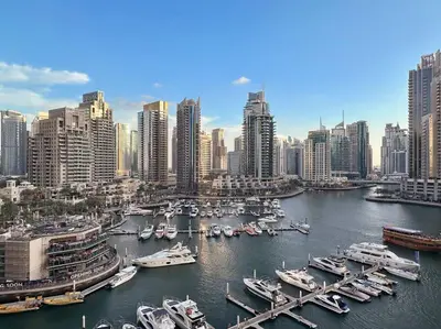 a group of boats docked in a harbor in a city at Luxury 2BR with Marina Views Near Dining Shopping Attractions & Beaches in Dubai