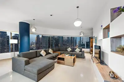 a living room with a couch and a table at Dubai Marina 3BR Apartment, Steps to Marina Walk, Marina Beach & JBR in Dubai