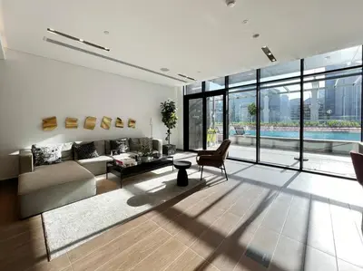 a living room with a couch and a table at Modern Studio Downtown DT1, Walk to Dubai Mall, Burj View & Metro in Dubai