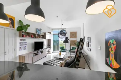 a living room with a couch and a tv at Keysplease 1 BR Polo Residence, Meydan in Dubai