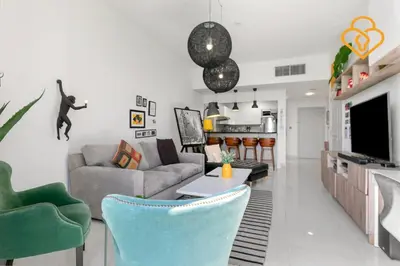 a living room with a couch and a table at Keysplease 1 BR Polo Residence, Meydan in Dubai