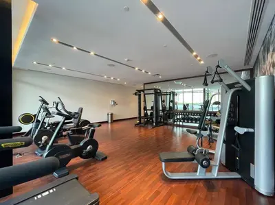 a gym with several treadmills and exercise bikes at FIRST CLASS Studio Stylish Urban Escape in Dubai