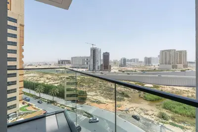 a view of a city from the balcony of a building at Nice apartment in JVC - Dubai in Dubai