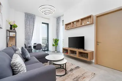 a living room with a couch and a tv at Nice apartment in JVC - Dubai in Dubai