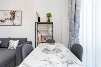 a living room with a table and a couch at Nice apartment in JVC - Dubai in Dubai