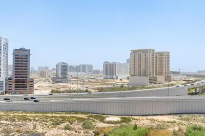 a highway in the middle of a city with tall buildings at Nice apartment in JVC - Dubai in Dubai