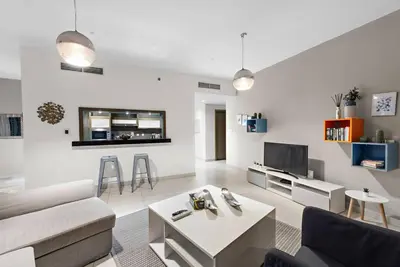 a living room with a couch and a table at FIRST CLASS 1BR Premium & Spacious City Escape in Dubai