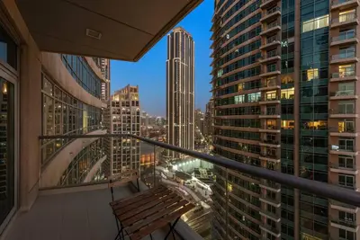 a balcony with a bench in a city at FIRST CLASS 1BR Premium & Spacious City Escape in Dubai