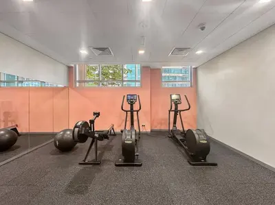 a gym with several exercise equipment in a room at FIRST CLASS 1BR Premium & Spacious City Escape in Dubai
