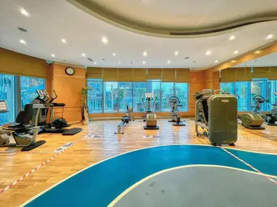 a gym with treadmills and exercise equipment in a room at FIRST CLASS 2BR Modern Downtown Retreat in Dubai