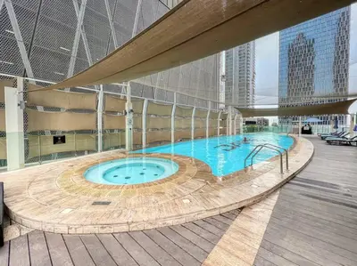 a large swimming pool in a building at FIRST CLASS 2BR Modern Downtown Retreat in Dubai