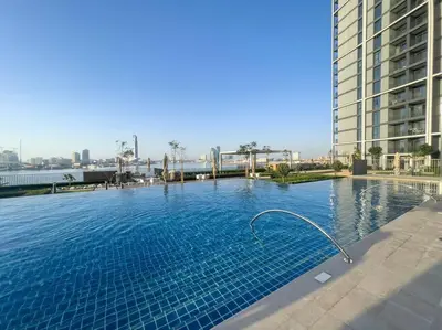 a large swimming pool in the middle of a building at Luxury Living with Panoramic View in Creek Harbour in Dubai