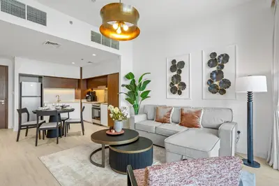 a living room with a couch and a table at Luxury Living with Panoramic View in Creek Harbour in Dubai