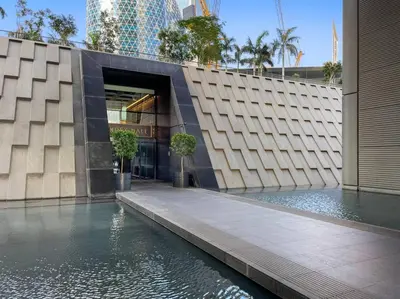 a building with a pool of water in front of it at FIRST CLASS 1BR Stunning Burj Khalifa Views in Dubai