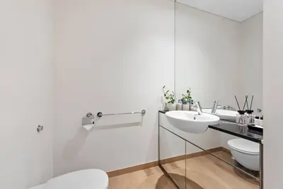 a white bathroom with a sink and a toilet at FIRST CLASS 1BR Stunning Burj Khalifa Views in Dubai