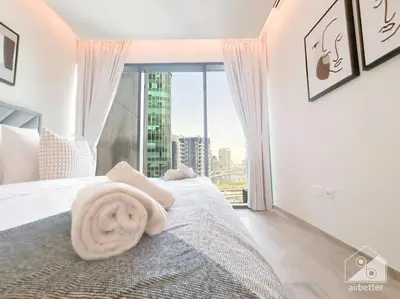 a bedroom with a bed with a towel on it at Luxurious 1Bedroom Balcony & View Business bay in Dubai