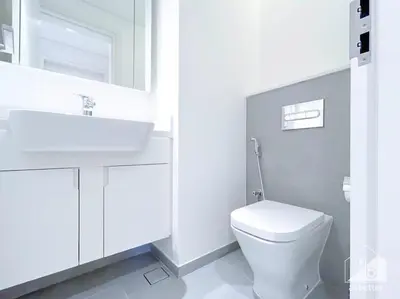 a white bathroom with a sink and a toilet at Luxurious 1Bedroom Balcony & View Business bay in Dubai