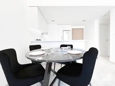 a dining room table with black chairs in a kitchen at Luxurious 1Bedroom Balcony & View Business bay in Dubai