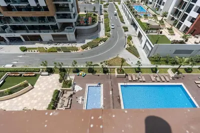 an aerial view of a building with a pool at 12 min from downtown - Studio - Azizi Riviera in Dubai