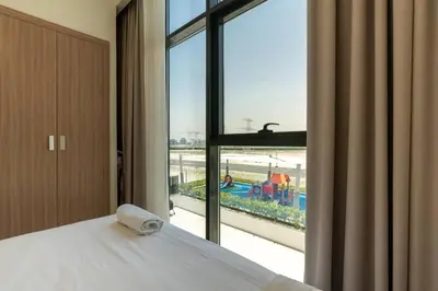 a bedroom with a bed and a large window at 1 bedroom - 12 min from downtown - Azizi Riviera in Dubai