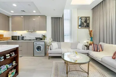 a living room with a couch and a table at 1 bedroom - 12 min from downtown - Azizi Riviera in Dubai