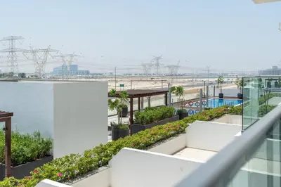 an apartment balcony with a view of the ocean at 1 bedroom - 12 min from downtown - Azizi Riviera in Dubai