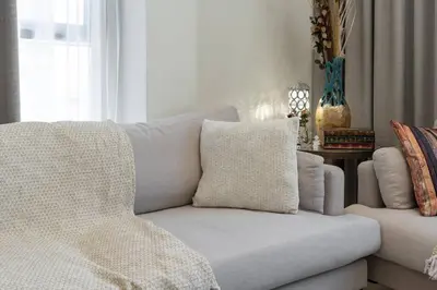 a couch and a chair in a living room at 1 bedroom - 12 min from downtown - Azizi Riviera in Dubai