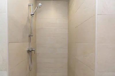a shower with a shower head in a bathroom at Studio - 12 min downtown - Pool - Azizi Riviera in Dubai