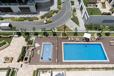 an overhead view of a swimming pool at a hotel at Studio - 12 min downtown - Pool - Azizi Riviera in Dubai