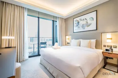 a hotel room with a bed and a large window at Elegant 2BR Apartment at The Address Residences Dubai Opera, Downtown Dubai by Deluxe Holiday Homes in Dubai