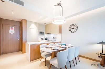 a kitchen and dining room with a table and chairs at Elegant 2BR Apartment at The Address Residences Dubai Opera, Downtown Dubai by Deluxe Holiday Homes in Dubai