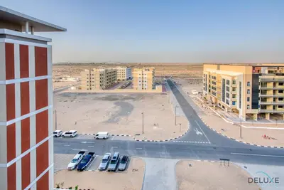 an aerial view of a parking lot in a city at Charming Studio in Celestia A, Dubai South by Deluxe Holiday Homes in Dubai