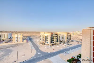 an aerial view of a city with buildings and a street at Charming Studio in Celestia A, Dubai South by Deluxe Holiday Homes in Dubai