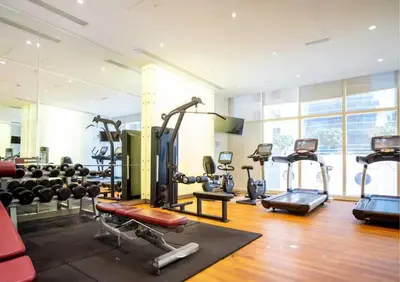 a gym with several treadmills and exercise machines at Luxe Sea View High Floor 1 BR in Dubai Marina by Maxx Value Homes in Dubai