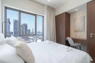 a bedroom with a large white bed and a window at New Listing & Vida Creek Beach & Beach Access in Dubai