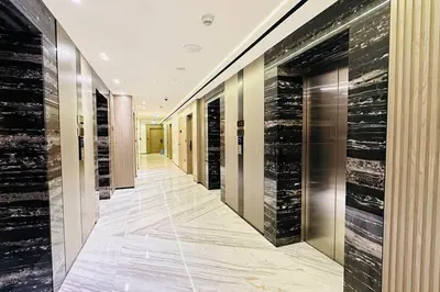 a hallway with black and gold walls and a walkway at Modern One Bedroom JVC in Dubai