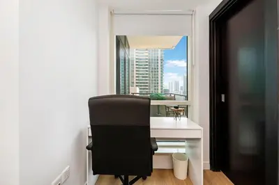 a desk and a chair in a room with a window at FAM Living - Panoramic Dubai Marina View apartment in Dubai