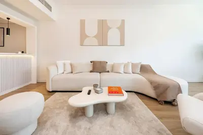 a living room with a white couch and a table at FAM Living - Panoramic Dubai Marina View apartment in Dubai