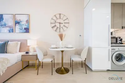 a bedroom with a bed and a table and chairs at Appealing Studio Apartment at Azizi Riviera 34, Al Merkadh by Deluxe Holiday Homes in Dubai