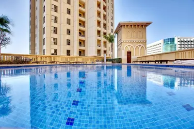 a large swimming pool in front of a building at 2BD apartment near the beach in Bahar, JBR in Dubai