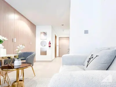 a living room with a couch and a table at Elegance at Aziz Riviera Studio & Balcony in Dubai