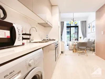 a white kitchen with a sink and a dishwasher at Elegance at Aziz Riviera Studio & Balcony in Dubai